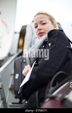 Woman boarding airplain. Stock Photo