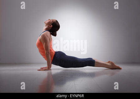 Sporty fit yogini woman practices yoga asana Urdhva mukha svanas Stock Photo