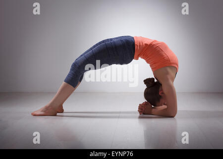 Beautiful sporty fit yogi girl practices yoga asana viparita dan Stock Photo