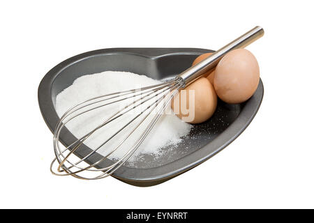 Preparation of a cake shaped like a heart for valentines day Stock Photo