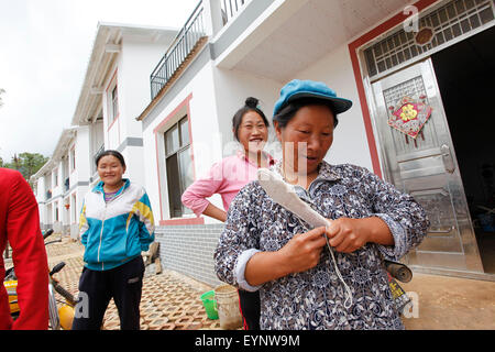 Zhaotong, July 31. 3rd Aug, 2014. Local residents chat at a resettlement community for victims of the Ludian earthquake one year ago in Qiaojia County, southwest China's Yunnan Province, July 31, 2015. A 6.5-magnitude earthquake jolted Ludian County in Yunnan at 4:30 p.m. on Aug. 3, 2014. As one year has passed, the post-disaster reconstruction for the quake victims has been pushing forward orderly. Credit:  Zhang Guangyu/Xinhua/Alamy Live News Stock Photo