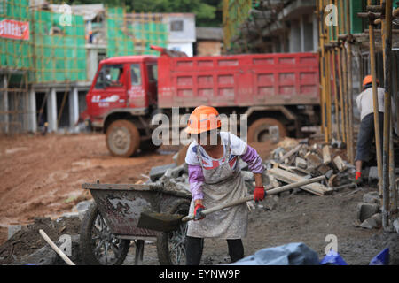 Zhaotong, July 31. 3rd Aug, 2014. Workers work at a construction site for the resettlement of victims of the Ludian earthquake one year ago in Qiaojia County, southwest China's Yunnan Province, July 31, 2015. A 6.5-magnitude earthquake jolted Ludian County in Yunnan at 4:30 p.m. on Aug. 3, 2014. As one year has passed, the post-disaster reconstruction for the quake victims has been pushing forward orderly. Credit:  Zhang Guangyu/Xinhua/Alamy Live News Stock Photo