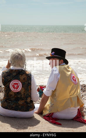 Sidmouth, Devon, UK. 2nd Aug, 2015. Morris dancers take in the sea views at Sidmouth Folk Week, which celebrates music and dance from 31st July to 7th August. The event has been going since 1955 and takes place during the first week of August. Credit:  Tony Charnock/Alamy Live News Stock Photo