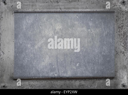 rusty metal plate on wooden background Stock Photo