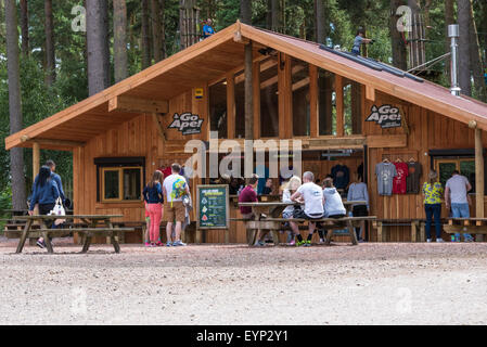 people sitting on benches outside Go Ape activity centre cannock chase Staffordshire West Midlands UK Stock Photo
