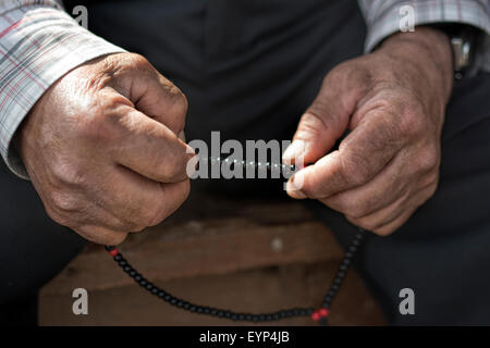 Old muslim Man with rosary praying Stock Photo