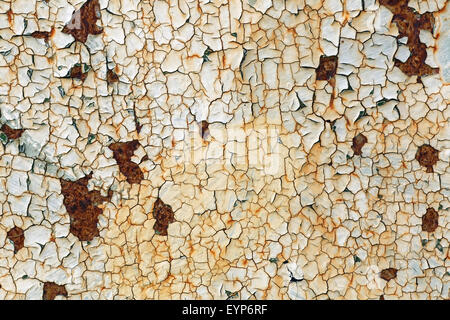 Grunge background with old peeling paint. Texture of rusty metal with cracked paint. Stock Photo