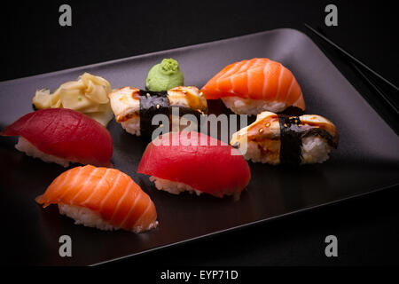 Eel, salmon and tuna sushi with chopsticks, top view