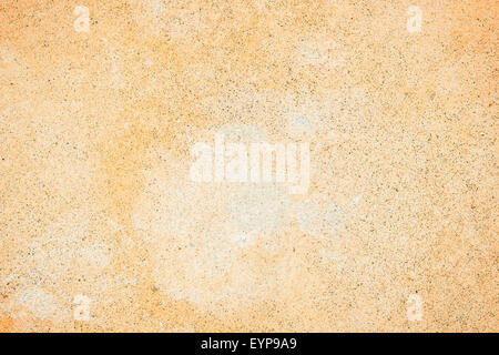 Pale orange concrete wall texture background with a bit of vignetting, paint partly faded. Stock Photo
