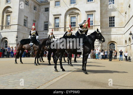 London, UK. 02nd Aug, 2015. A trooper falls off his horse at Horse Guards Parade, London, UK, during the changing of the guard on the morning of 2nd August. The trooper was trying to dismount when he appeared to get his foot caught in the stirup. The horse reared up and down he went. Credit:  Paul Briden/Alamy Live News Stock Photo