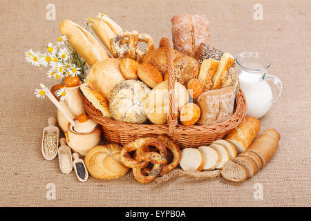 Composition of various baked products in basket on rustic background Stock Photo