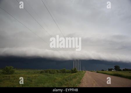 A large shelf cloud rolling over a rural area of Nebraska. Stock Photo
