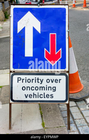 Traffic sign Priority Over Oncoming Vehicles for an unsignalled contraflow past roadworks Stock Photo