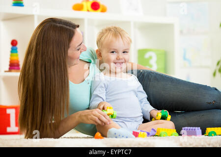 kid playing with building blocks at kindergarten Stock Photo