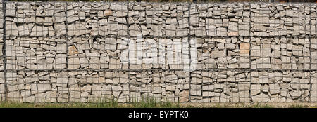 Gabion wall made of grey stones.  Stone wall. Stock Photo