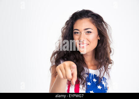Happy teen girl pointing finger at camera isolated on a white background Stock Photo