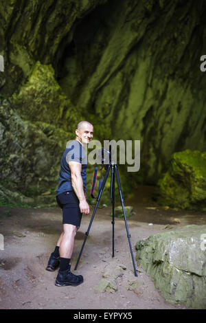 Professional landscape photographer taking shots in a cave Stock Photo