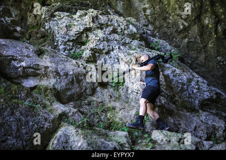 Professional landscape photographer taking shots in a cave Stock Photo