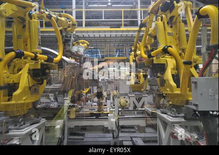 Inside a modern car factory, vehicles and parts move through the production process robots welding car bodies Stock Photo