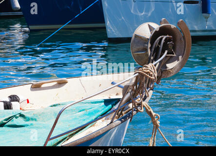 Fragment of small wooden fishing boat with bow winch Stock Photo