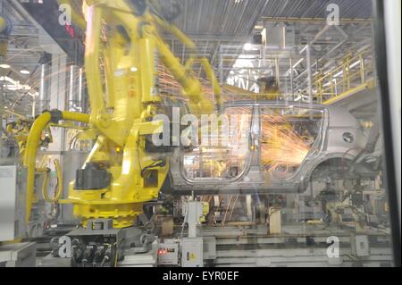 Inside a modern car factory, vehicles and parts move through the production process robots welding car shell Stock Photo
