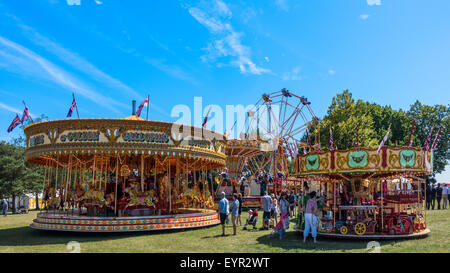 Vintage Funfair Fairground Carousel Galloping Horses Merry go Round Big Wheel Chairoplane Stock Photo