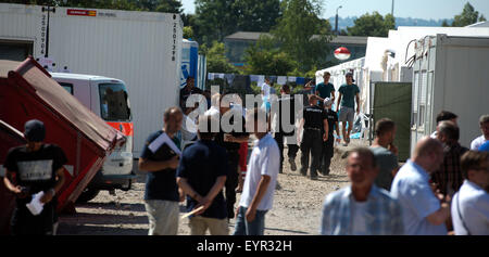 Dresden, Germany. 03rd Aug, 2015. Security guards walk through the emergency shelter for refugees in Dresden, Germany, 03 August 2015. Saxony's Interior Minister visited the shelter and informed himself about the work of the German Red Cross (DRK), the Federal Agency for Technical Relief (THW) and the housing situation of refugees in the emergency camps of the refugee arrival centers. Photo: Arno Burgi/dpa/Alamy Live News Stock Photo