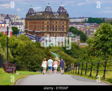 Two couples strolling towards Scarborough's famous Grand Hotel Stock Photo