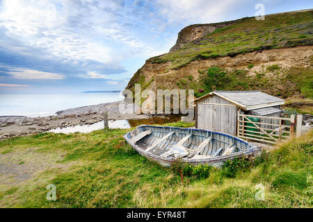 An old wooden boat on the beach at Millook Haven near Bude on the Cornwall coast Stock Photo