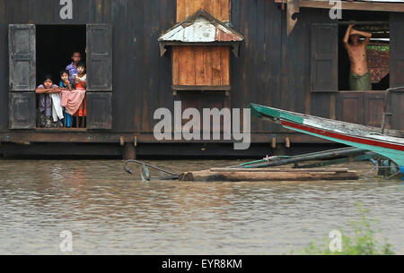 Magway Region, Myanmar. 3rd Aug, 2015. Local residents look out from their flooded-house at Minbu district in Magway region, Myanmar, on Aug. 3, 2015. Heavy monsoon rains have left at least 47 people dead and affected more than 210,000 others in 12 out of Myanmar's 14 states and regions since June, the Ministry of Social Welfare, Relief and Resettlement said on Monday. Credit:  Kyaw Zaya/Xinhua/Alamy Live News Stock Photo