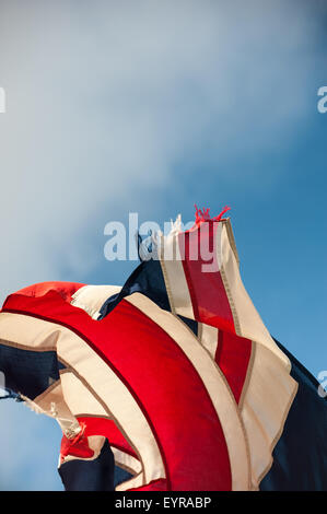 England. Ragged, tattered, torn flying Union Jack. Stock Photo