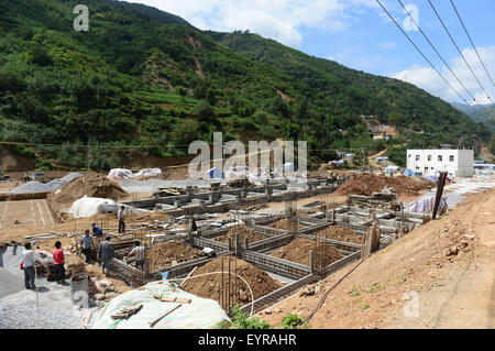 Ludian, July 30. 3rd Aug, 2014. Houses are under construction in Longtoushan Town of Ludian County, southwest China's Yunnan Province, July 30, 2015. A 6.5-magnitude earthquake jolted Ludian County in Yunnan on Aug. 3, 2014. As one year has passed, the post-disaster reconstruction has been pushing forward orderly. © Hu Chao/Xinhua/Alamy Live News Stock Photo