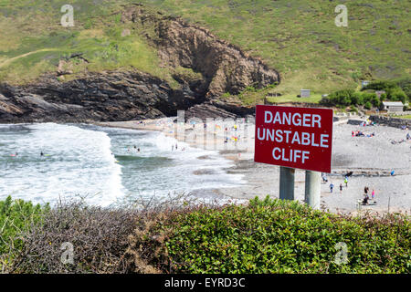 Danger Unstable Cliff Warning Sign on the South West Coast Path at Crackington Haven, Cornwall England UK Stock Photo