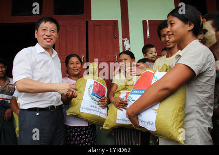 Kalay, Myanmar. 3rd Aug, 2015. Chinese Ambassador to Myanmar Hong Liang (front L) donates relief supplies to flood-hit residents in Kalay township of Sagaing Region, Myanmar, on Aug. 3, 2015. The Chinese Embassy to Myanmar on Monday provided humanitarian aid to Myanmar's flood-hit regions. Credit:  Ko Thaung/Xinhua/Alamy Live News Stock Photo