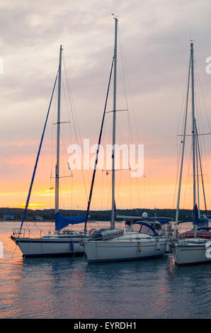 Sunset with Sailboats Vertical in Pula, Croatia Stock Photo