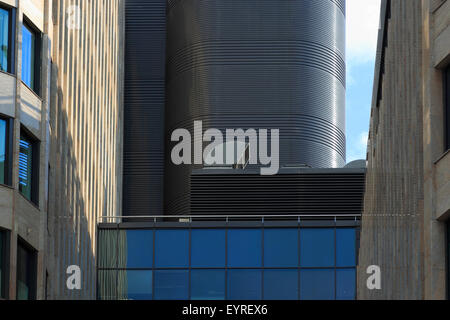 Modern office building with industrial air conditioning and ventilation systems on a roof. Stock Photo