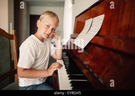 boy plays piano at home Stock Photo