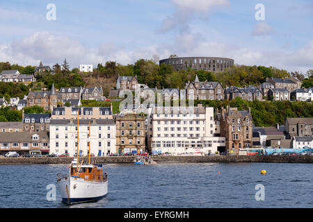 Waterfront buildings with Regent Hotel and War & Peace museum with McCaig's tower folly above. Oban Argyll and Bute Scotland UK Stock Photo
