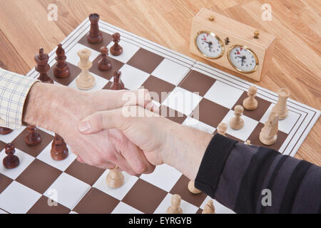 Shaking hands by the end of a chess match Stock Photo