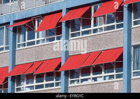 Facade of a modern building with red sunshades Stock Photo