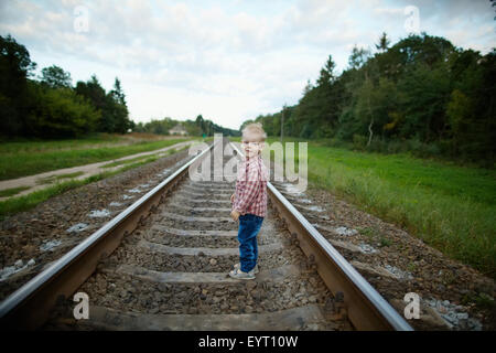 boy playing on the railroad Stock Photo