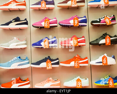 Puma training shoes display in sports store. Stock Photo