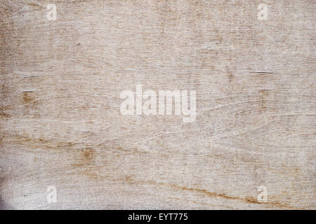 Close-up of a cracked and weathered plywood texture background with a bit of vignetting. Stock Photo
