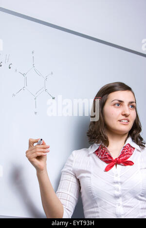 Joyful young chemistry teacher presenting benzene (benzol), an organic chemical compound. Stock Photo