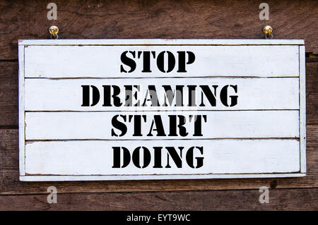 Stop Dreaming Start Doing Inspirational message written on vintage wooden board. Motivation concept image Stock Photo