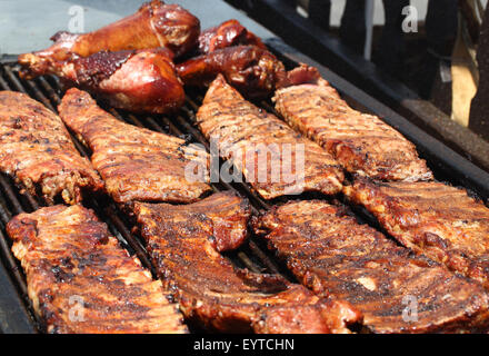 Juicy barbecue ribs cooking on open grill Stock Photo