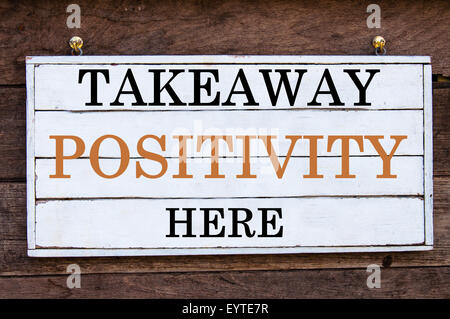 Takeaway Positivity Here Inspirational message written on vintage wooden board. Motivation concept image Stock Photo