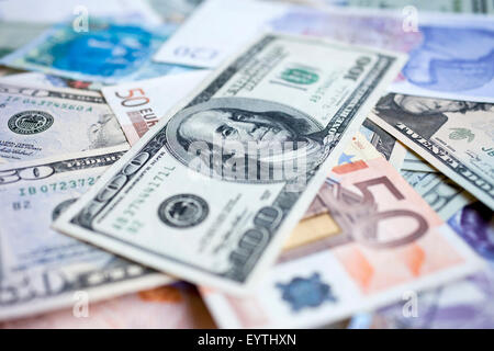 A pile of international bank notes including the US dollar, Euro, British pound and Hong Kong Dollar. Stock Photo