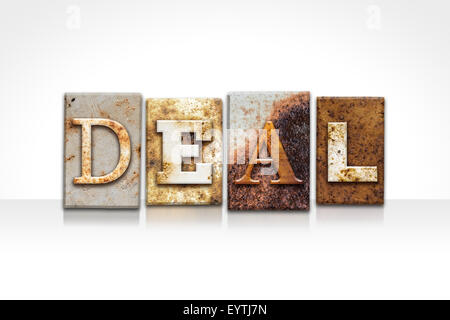 The word 'DEAL' written in rusty metal letterpress type isolated on a white background. Stock Photo
