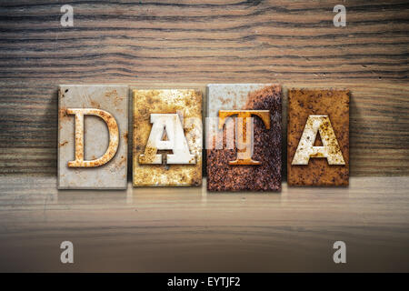 The word 'DATA' written in rusty metal letterpress type sitting on a wooden ledge background. Stock Photo